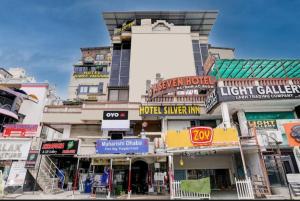 a building with many signs on the side of it at Hotel Captown Inn in Ahmedabad