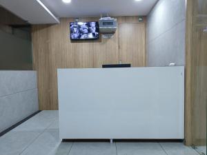 a white table in a room with a tv on a wall at Hotel Captown Inn in Ahmedabad +22 photos