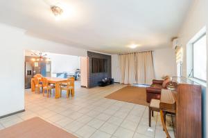 a living room with a table and a couch at Urban Escapes - LINDEN COTTAGE in Johannesburg