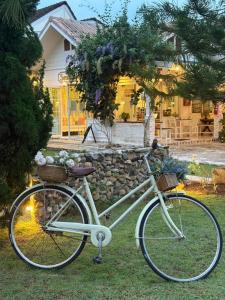 a white bike parked in front of a house at Charisma Resort in Suan Phung