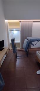 a living room with two chairs and a table at Sweetmar guest Rooms-ground floor in Kos