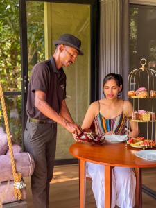a man and a woman standing next to a table at The Blackberry Retreat Kandy in Kandy