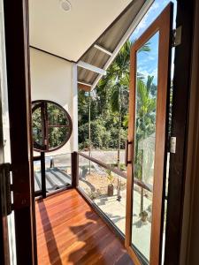 an open door to a balcony with a view at Bearwolf Koh Kood in Ko Kood +17 photos