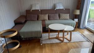 a living room with a couch and a table at Hus 25 Wandlitz Zerpenschleuse in Wandlitz