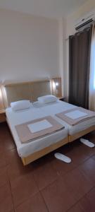 a bedroom with a large bed in a room at Sweetmar guest Rooms-ground floor in Kos