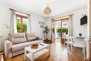 a living room with a couch and a table at Apartamentos Mar Blanca by Mauter Villas in Cala Blanca