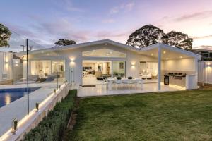 a modern house with a pool and a backyard at Casa Bianca - Fireplace with Swimming Pool in Callala Beach