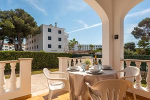 a table and chairs on a balcony with a view of a building at Apartamentos Mar Blanca by Mauter Villas in Cala Blanca