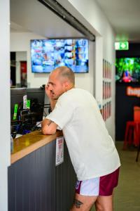 a man standing at a counter in a store at MOM Darwin in Darwin