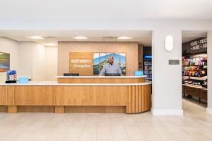 a man standing at the counter of a store at Hampton Inn & Suites Redding in Redding +46 photos