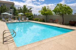 a swimming pool with blue water in a resort at Hampton Inn & Suites Redding in Redding