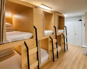 a group of bunk beds in a room at Moonraejung Hostel in Seoul