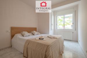 a bedroom with a bed with a hat on it at Casa Aiguamarina in Palamós
