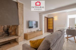 a living room with a couch and a fireplace at Casa Aiguamarina in Palamós