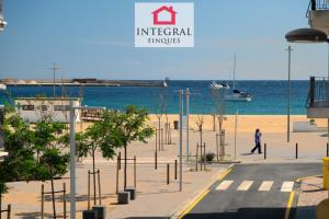 a person walking on a beach near the water at Casa Aiguamarina in Palamós