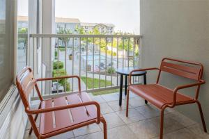 two chairs and a table on a balcony with a view at Hampton Inn & Suites Redding in Redding