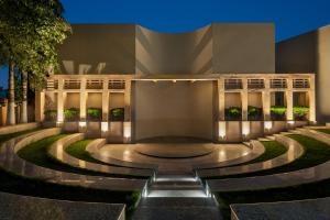 a building with a fountain in front of it at Ramada by Wyndham Bodh Gaya Mahabodhi in Bodh Gaya