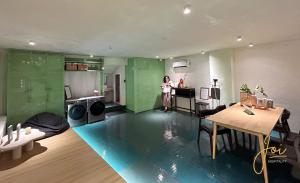 a woman is standing in a room with a kitchen at Joi Home Beachfront in Vung Tau +15 photos