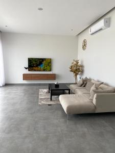 a living room with a couch and a table at Rove Chalet in á¸¨arÄdÄ«