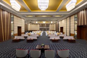 a banquet hall with tables and chairs in a room at Ramada by Wyndham Bodh Gaya Mahabodhi in Bodh Gaya +49 photos