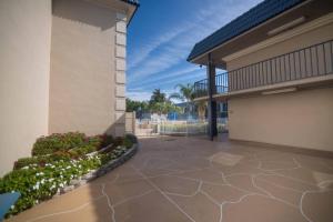 a patio in a home with a building at Clarion Inn & Suites Central Clearwater Beach in Clearwater