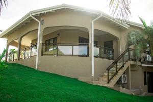 a large house with stairs and a green lawn at Golden Pear Villa-CR in Confer