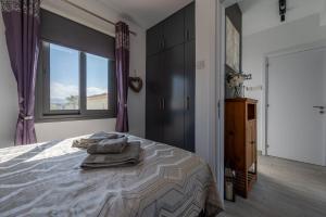 a bedroom with a large bed with a window at The Summer Haven in Polis Chrysochous +55 photos