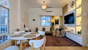 a living room with a table and chairs at Cityloft Bungalow in Dauis