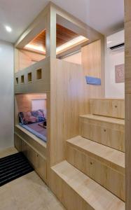 a room with a bunk bed with wooden shelves at Cityloft Bungalow in Dauis +37 photos