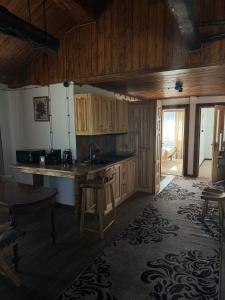 a kitchen with wooden cabinets and a counter top at Глинобитні будиночки in Darakhov