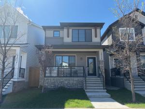 a large house with a staircase in front of it at Beautiful New House in Alpine Park, Calgary in Calgary