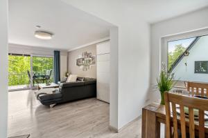 a living room with a couch and a table at Ferienwohnung Sauerland an der Ruhr in Olsberg