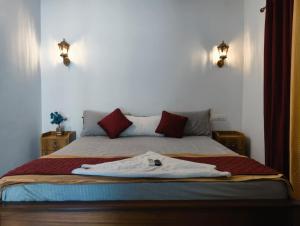 a bedroom with a bed with a robe on it at Shampagne Villa in Cochin +9 photos