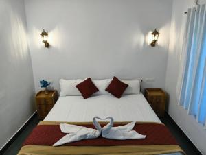 a bedroom with a bed with two white towels at Shampagne Villa in Cochin