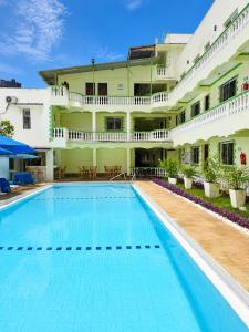 a large swimming pool in front of a building at Prestige Leisure Hotel in Mtwapa
