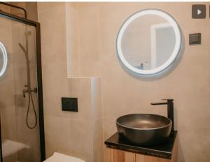 a bathroom with a sink and a mirror at Urban Nest Tuzla in Tuzla +3 photos