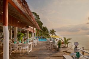 a restaurant on the beach with a view of the water at One Beach Resort by EHM in Koh Rong Sanloem