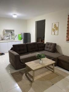 a living room with a brown couch and a coffee table at As Thetic Transient in San Pablo