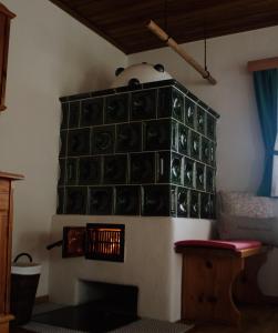 a room with a fireplace with green plates on the wall at Ferienhaus Trausibauer in Stainz