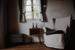 a living room with a chair and a television at Ferienhaus Trausibauer in Stainz