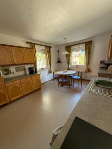 a kitchen with a table and a dining room at Landhäuschen in Kirchbach