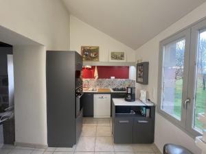 a small kitchen with a refrigerator and a stove at Gites de Gondières in Saint-Éloi +9 photos