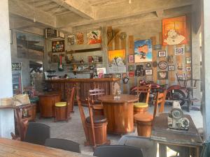 a restaurant with wooden tables and chairs and a bar at Baan Archa Samui in Bophut