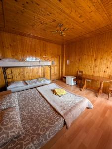 a bedroom with a bed in a wooden room at Бирюза in Karolino-Buhaz