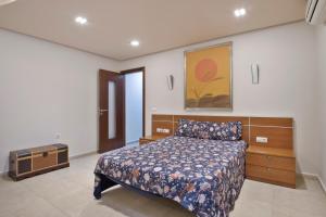 a bedroom with a bed and a tv in it at Casa Emma in Playa Honda