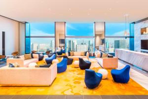 a living room with a view of the city at The Prince Gallery Tokyo Kioicho, a Luxury Collection Hotel in Tokyo