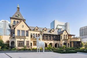 a statue of a giraffe in front of a building at The Prince Gallery Tokyo Kioicho, a Luxury Collection Hotel in Tokyo