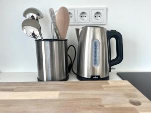 a kitchen counter with two coffee pots and utensils at Casa Calmavista in Paços de Gaiolo