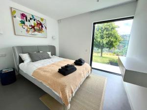 a bedroom with a bed and a large window at Casa Calmavista in Paços de Gaiolo +107 photos