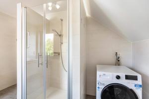 a washer and dryer in a bathroom with a shower at Ferienwohnung Niemeier in Brilon +29 photos